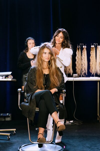 Model getting hair done by Danielle K White on stage at hair show