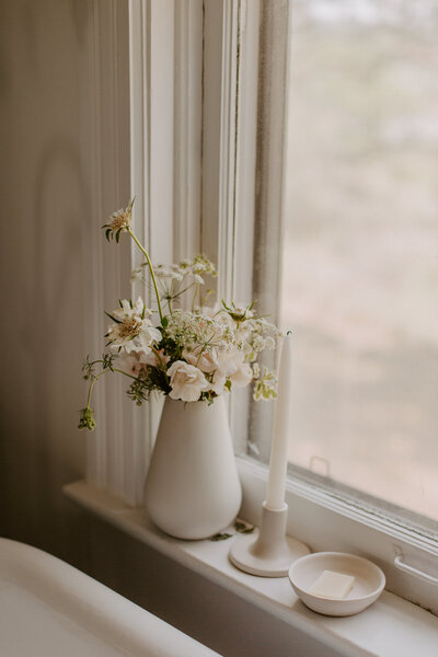 Plants and candles on a window ledge