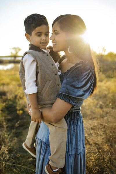 a mom embraces her son in the park in the colony texas