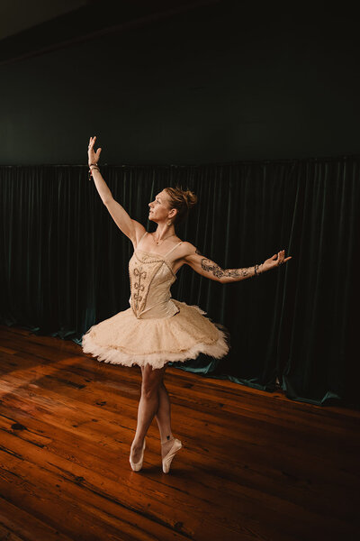 A ballet dancer dancing in a small studio 