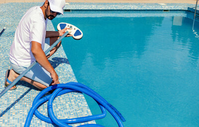man making sure a Swimming pool chemical balancing Chesapeake VA is being completed