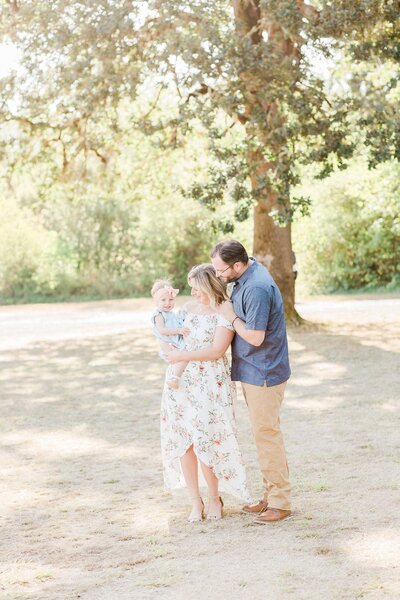 family of three at champoeg state park for morning family photos