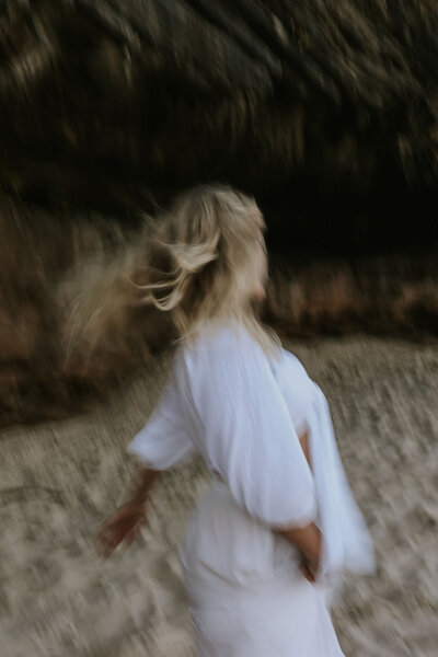 Blurry image of woman dancing/running on the beach 
