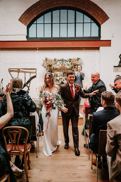 Wedding ceremony with  mismatched chairs at peddler warehouse