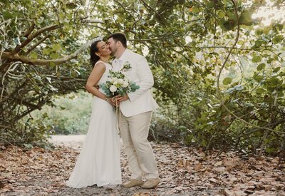 groom kisses brides cheek
