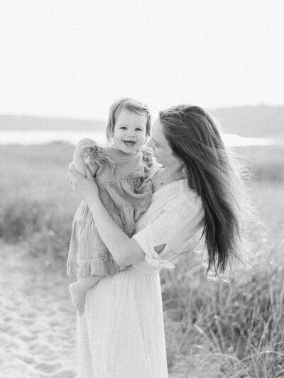mother playing with daughter on the  beach By Carrie Pellerin
