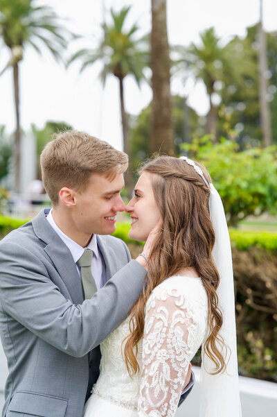 Stealing kisses during their wedding at the LDS Oakland Temple in Oakland, California