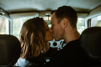 D & D kissing in the front seat of their jeeps
