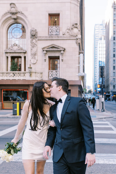 couple kissing on a crosswalk