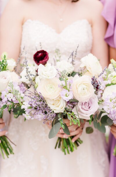 bride holding her lavender bouquet of flowers