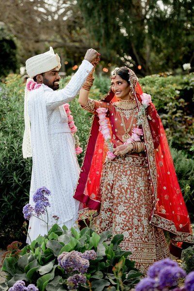 Vibrant indian wedding in a chich garden setting near sunset