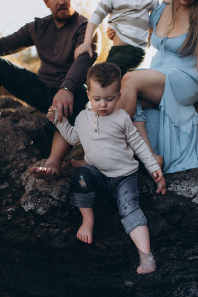 Child dipping his toes in the water in Scottsdale