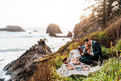 Bride and groom having a picnic along the Oregon Coast after their elopement