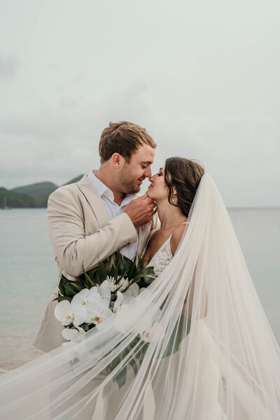 St. Lucia Intimate Wedding.  Flowing veil on the beach in front of mountains