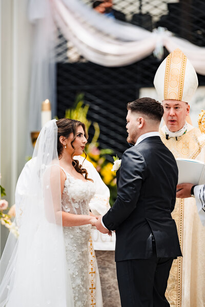 Bride & groom at the nuptial blessing in Christ Cathedral Orange Ca