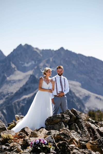 A couple taking bridal photos on a mountain peak in Stanley, Idaho