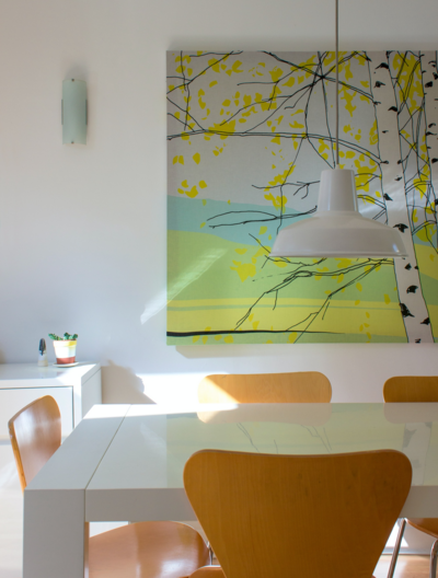 Scandinavian-style dining room with bold wall art in a freshly cleaned Edmonton home by eco-friendly cleaning services