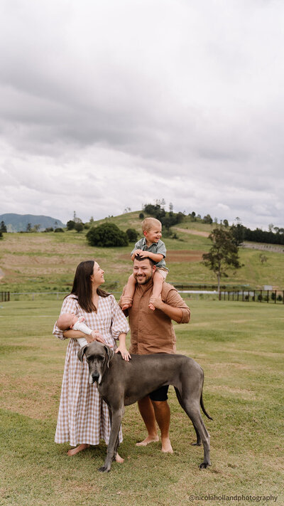 kara's family of four with their dog outside