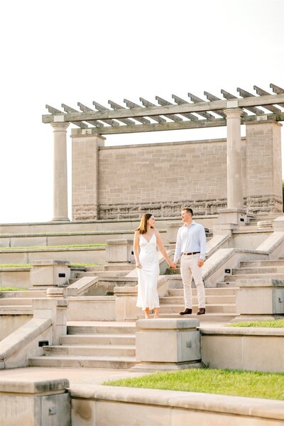 Bride and Groom posing on the steps at Coxhall Gardens, a wedding venue and Carmel Clay Park in Carmel, IN