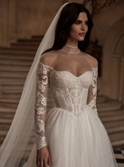 Milla Nova stock photo of a bride wearing a ball gown basque waist lace dress with a long veil