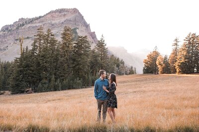 Cute couple standing in field at Crater Lake National Park