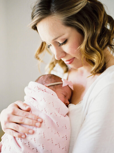 mother and daughter snuggle during session By Carrie Pellerin