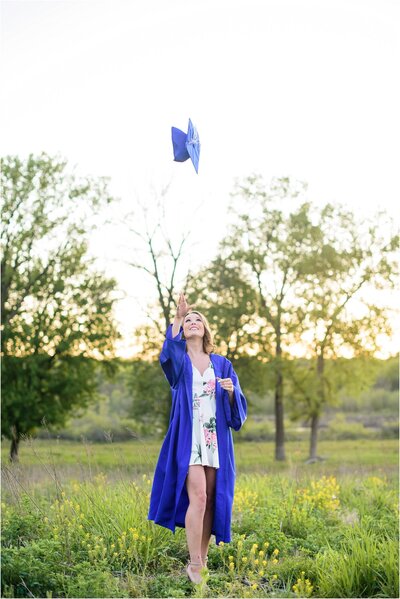 high school senior throwing graduation cap into the air