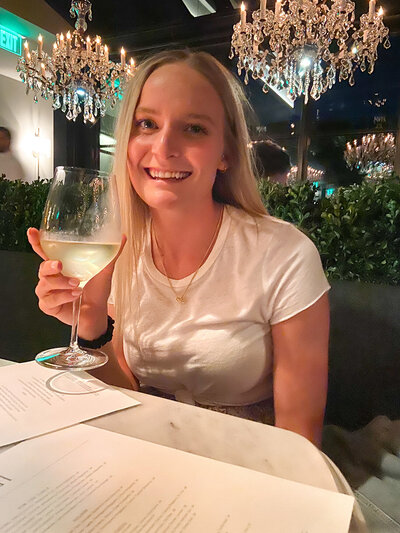 woman holds glass of wine