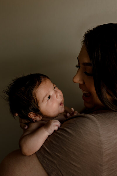 San Antonio newborn baby smiling at mom