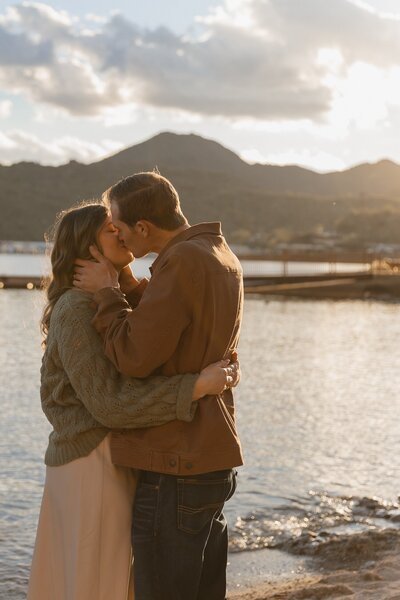 couple kisses in front of lake in arizona