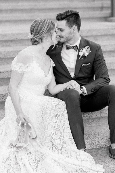 Bride and groom kissing on steps