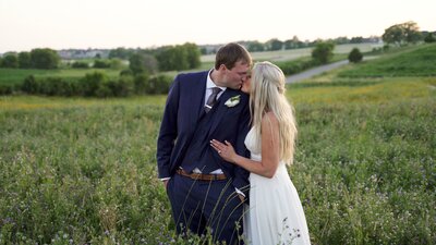 A Bride and Groom kiss. In Field at Bavaria Downs Chaska, MN