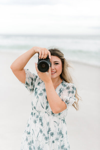Abby Bell, a fine art wedding and portrait photographer in Alabama, captured on a beach with her camera. Specializing in luxury and personalized photography, Abby Bell Photography provides romantic wedding, engagement, and couples sessions, delivering timeless and fine art portraits across Alabama.
