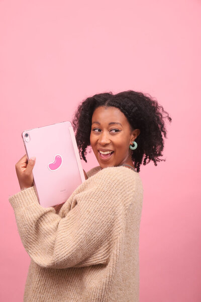 Mighty Bean Co. founder holding an iPad with a brand sticker