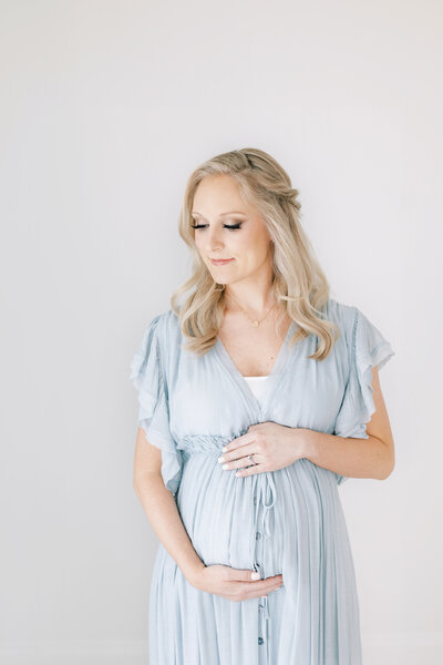 a pregnant woman in a blue dress