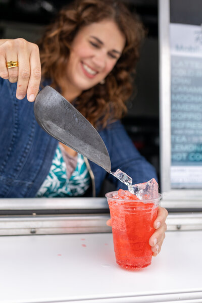 ice being added to fruit flavored beverage