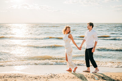 couple walking on the beach - annapolis engagement session