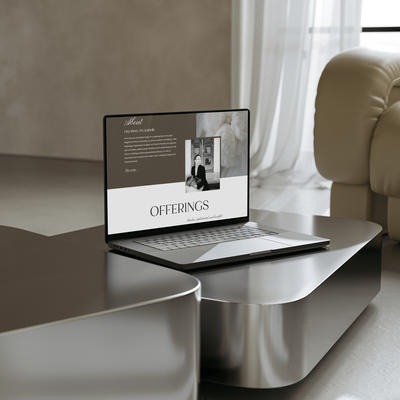 Laptop open on table with photographers website on it