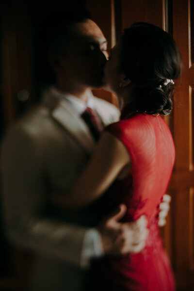 couple kissing infront the door