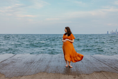 Pregnant woman during waterfront maternity session in Chicago, IL