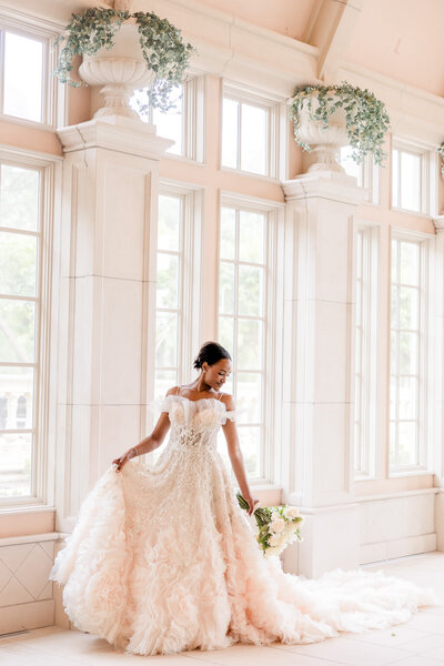 Bride twirls her dress at The Olana Wedding Venue in Hickory Creek, Texas/