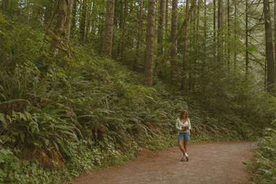 girl walking on trail in washington nature park