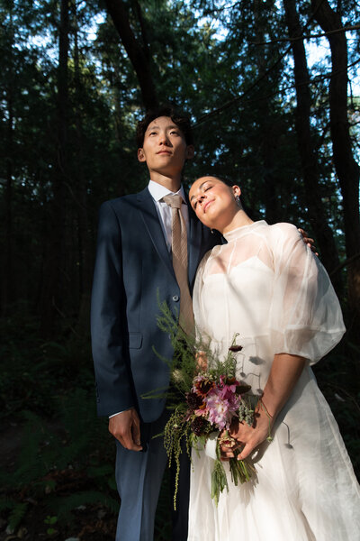 Just married couple poses for portraits after their wedding.