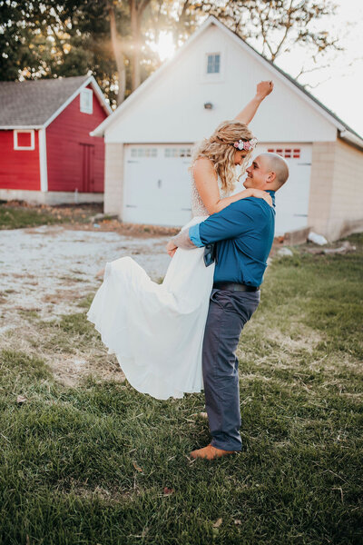 Groom twirling bride in her dress during golden hour portraits in Frankfort, IL