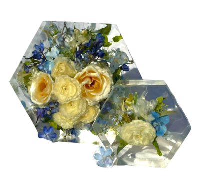 white and blue bouquet preserved in a hexagon shaped resin block