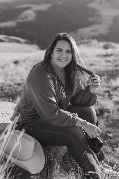 woman sitting on a rock while smiling