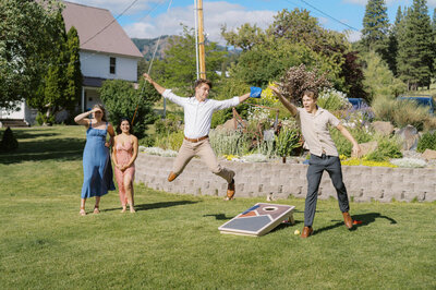 Wedding guest leaps in the air while playing lawn games.