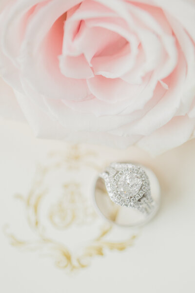 wedding ring next to a pink flower