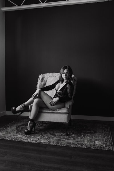 Magan Rogers posing in a minimalist setting in her studio downtown Ferndale.