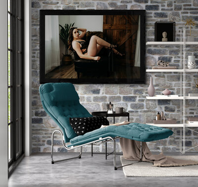 Stone wall with framed image of a woman during her luxury boudoir session with Kerry Callahan Boudoir
